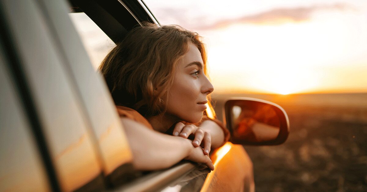 someone looking out a car window and wondering if they're pregnant